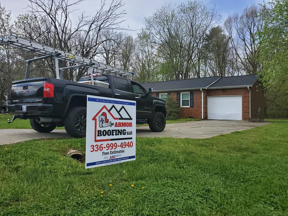 Armor Roofing project sign and truck